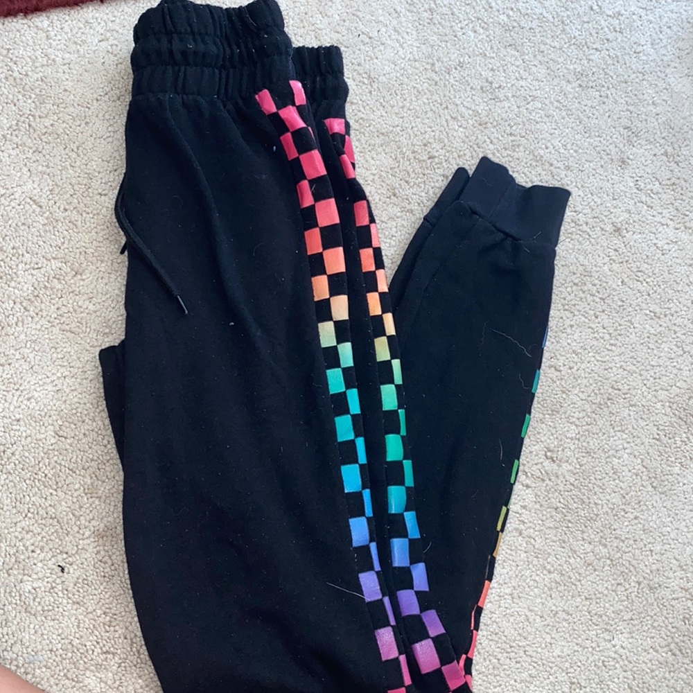 Black sweatpants with checkered rainbows on the sides